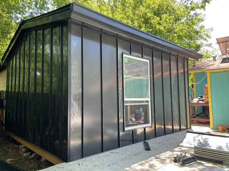 Black standing seam metal wall panels for Roof Inspection in Sunset